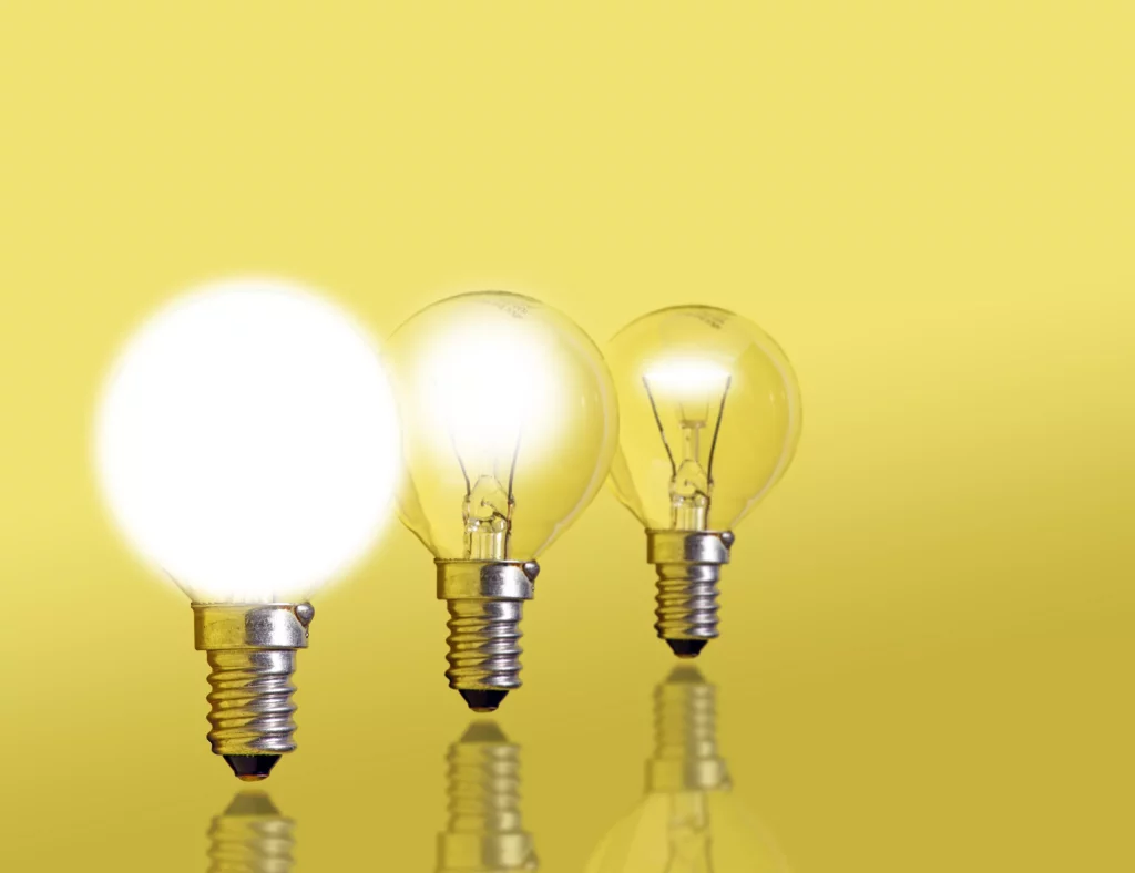 three lightbulbs in a row. the first is off, the second is dim, and the third is shining brightly